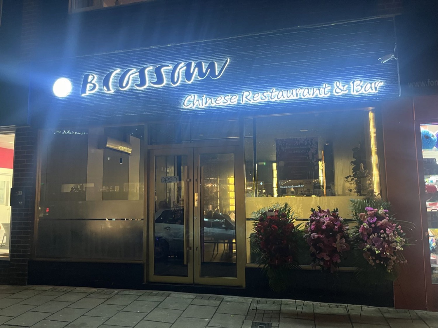 Blossom Chinese Restaurant & Bar shopfront glowing on Old Milton Road at night