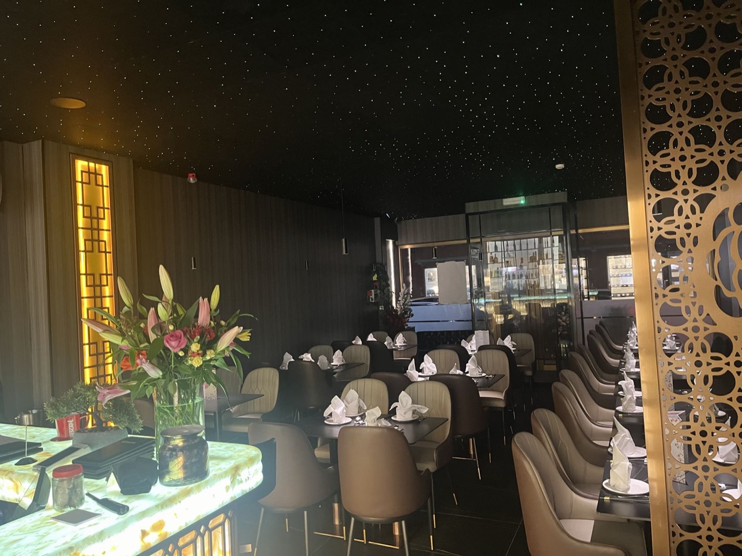 Dining room with gold fretwork screens and starlit ceiling